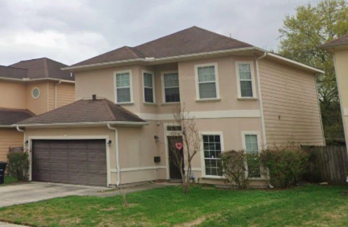 beige 2-storey house with garage